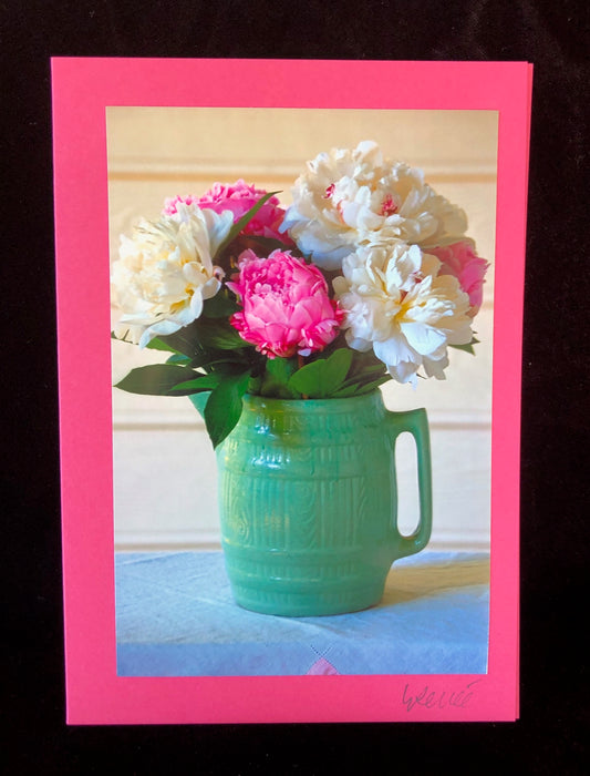 White and pink peonies in vintage green pitcher.