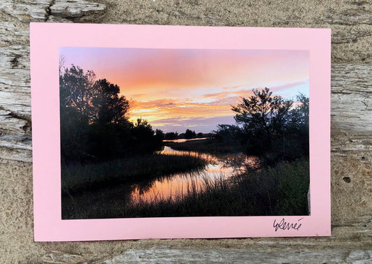 Stunning pink, gold, lavender sunrise with sky reflected in Bonnet's Creek.