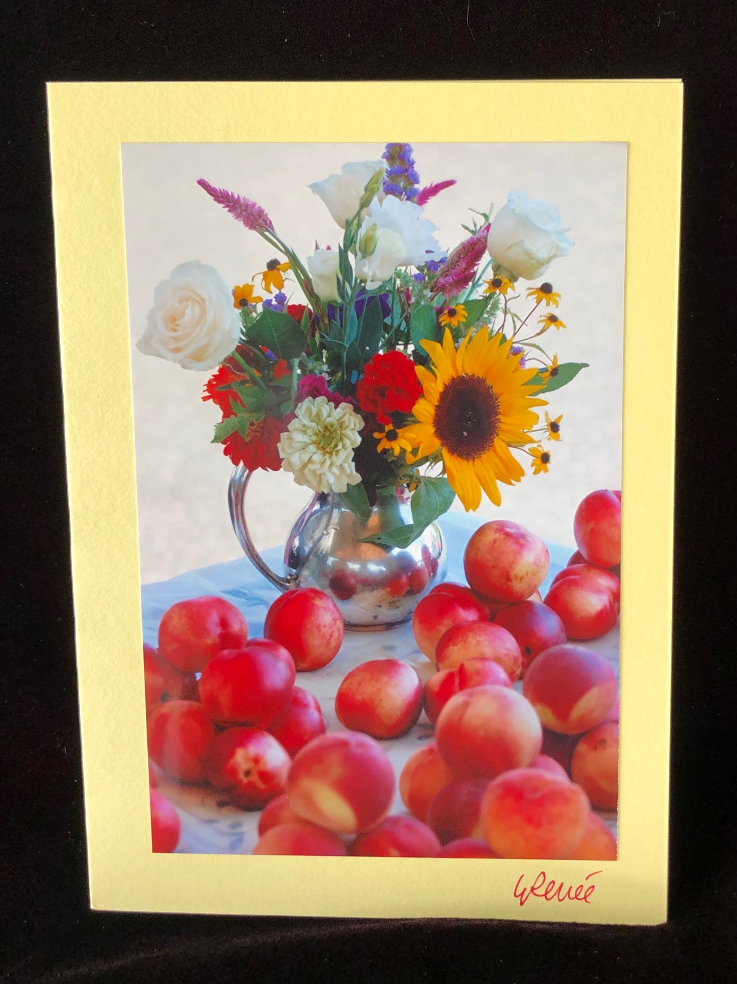 Sunflower bouquet in vintage, silver tea pot with nectarines on the table.