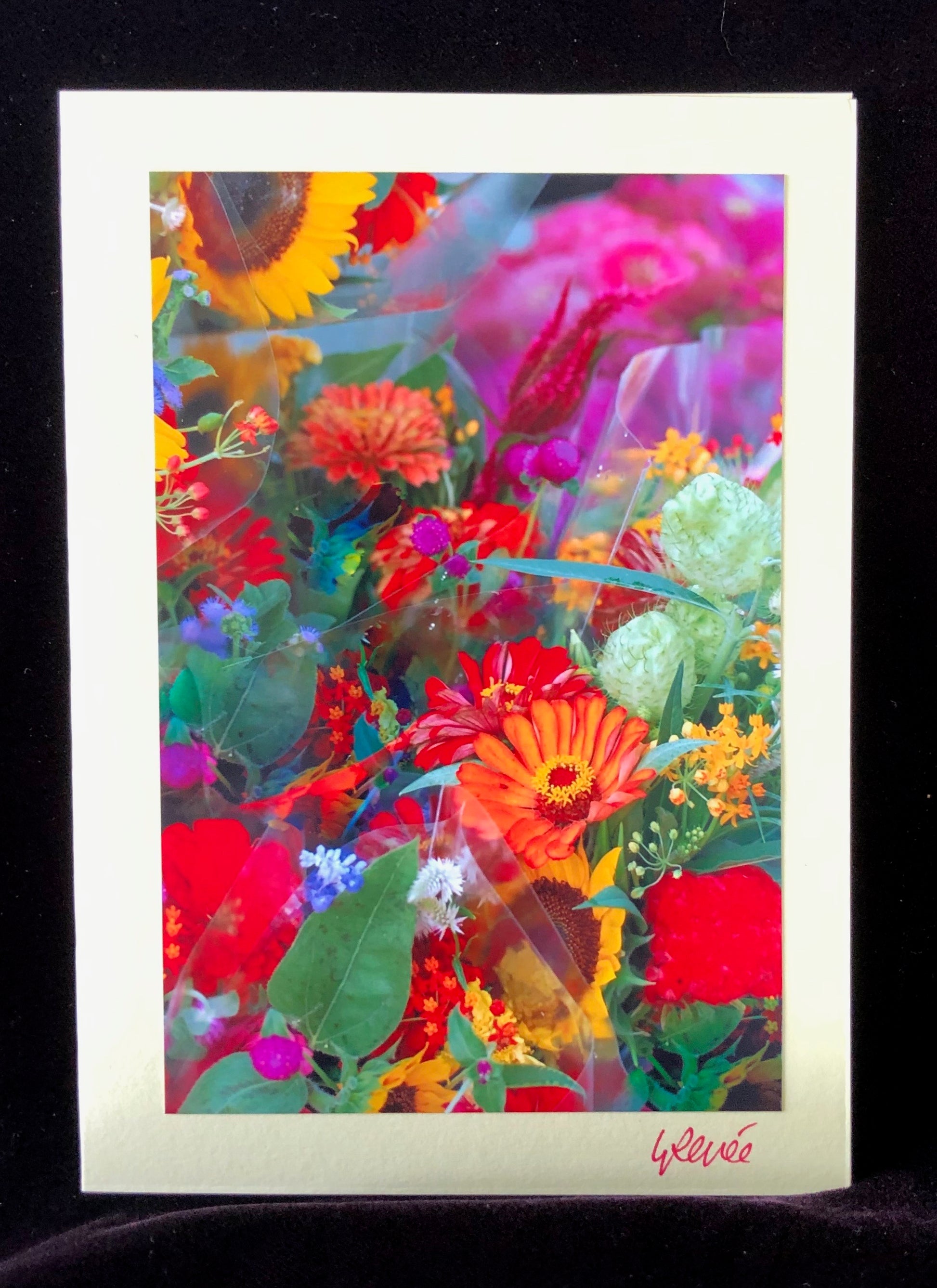 Bouquet of colorful sunflowers and zinnias at farmers market booth.